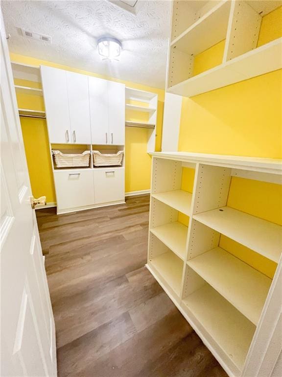 laundry room with visible vents and wood finished floors