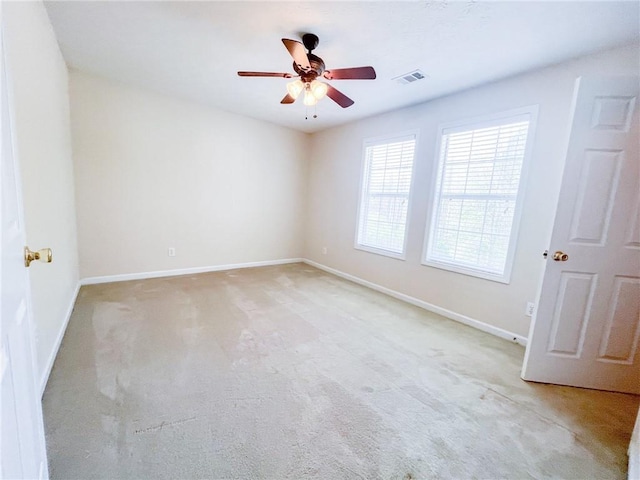 unfurnished room featuring visible vents, a ceiling fan, baseboards, and light colored carpet