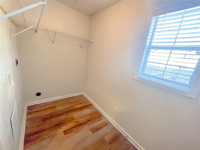 washroom with baseboards and light wood-type flooring