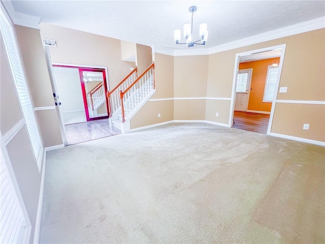 interior space featuring ornamental molding, baseboards, stairway, carpet flooring, and a notable chandelier