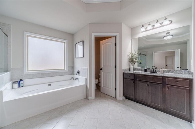 carpeted bedroom with a raised ceiling, ceiling fan, and ensuite bathroom