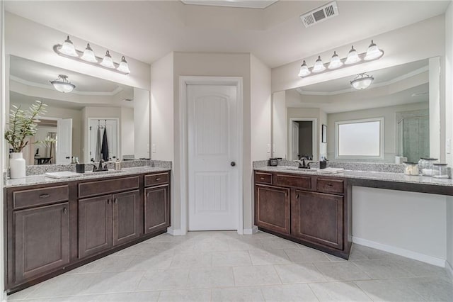 bathroom featuring vanity, a tray ceiling, ornamental molding, and tile patterned floors