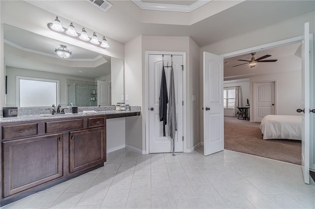 bathroom with walk in shower, ornamental molding, vanity, a raised ceiling, and ceiling fan