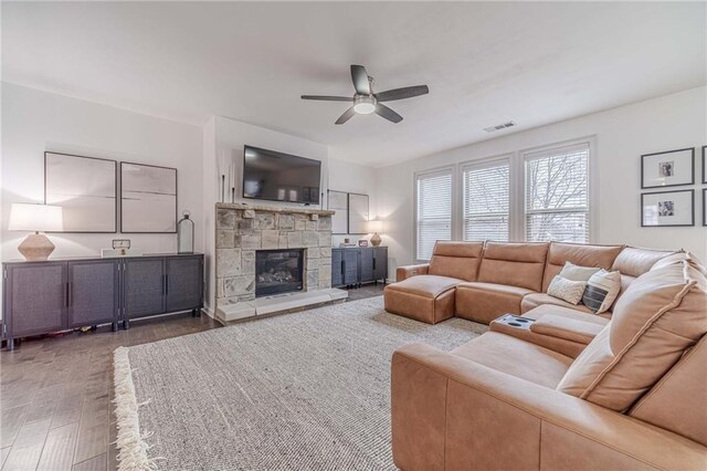 rec room with coffered ceiling, ceiling fan with notable chandelier, dark hardwood / wood-style floors, and beamed ceiling