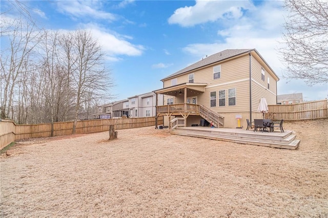 rear view of property featuring a wooden deck