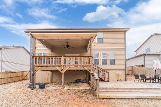 back of property with a wooden deck and ceiling fan