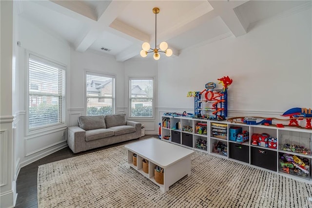 game room featuring beamed ceiling, wood-type flooring, coffered ceiling, and an inviting chandelier