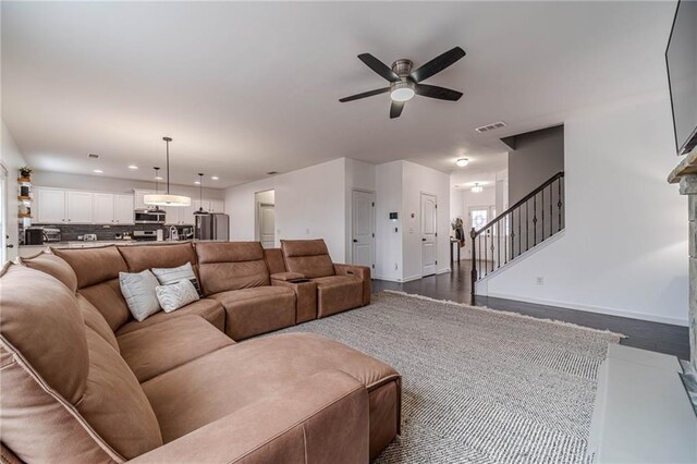 living room featuring dark hardwood / wood-style floors, decorative columns, beamed ceiling, ornamental molding, and coffered ceiling