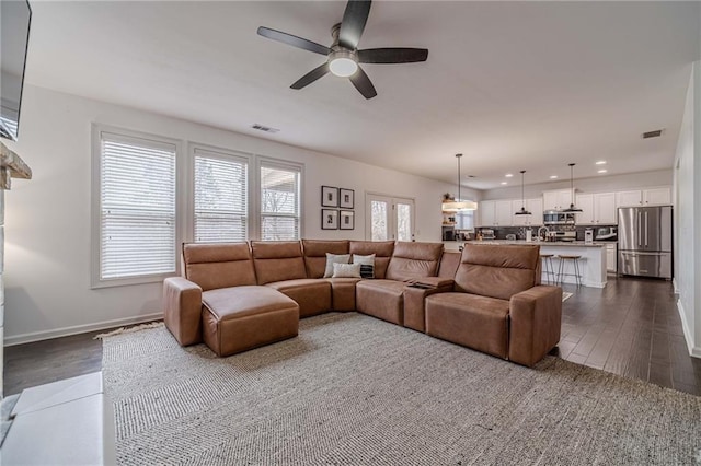 living room with dark wood-type flooring and ceiling fan