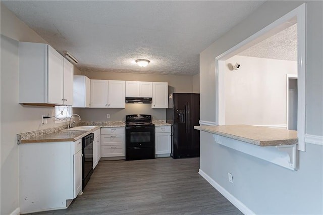 180 Sears Cir, Covington, GA 30016 - kitchen featuring white cabinetry, sink, black appliances, and a textured ceiling