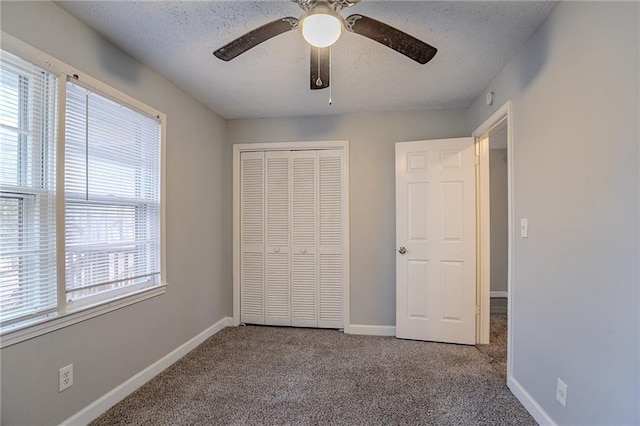180 Sears Cir, Covington, GA 30016 - unfurnished bedroom with ceiling fan, a closet, a textured ceiling, and carpet flooring
