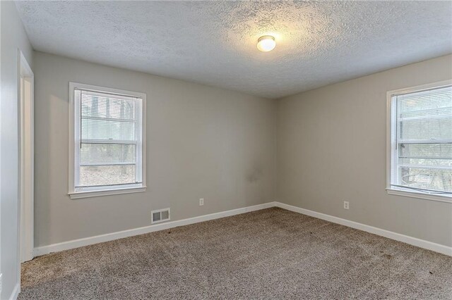 180 Sears Cir, Covington, GA 30016 - empty room with carpet floors and a textured ceiling
