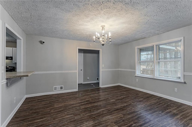 180 Sears Cir, Covington, GA 30016 - interior space with dark hardwood / wood-style floors, a textured ceiling, and an inviting chandelier