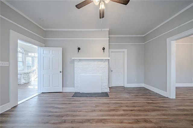 unfurnished living room featuring hardwood / wood-style flooring, ornamental molding, ceiling fan, and a fireplace