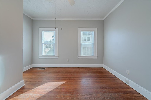 spare room featuring wood-type flooring and ornamental molding