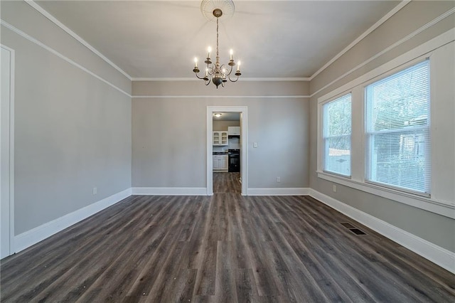 unfurnished dining area with dark wood-type flooring, an inviting chandelier, and crown molding