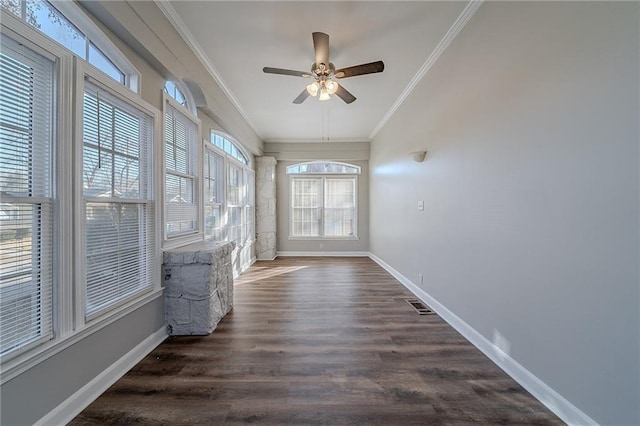 unfurnished sunroom featuring ceiling fan and plenty of natural light