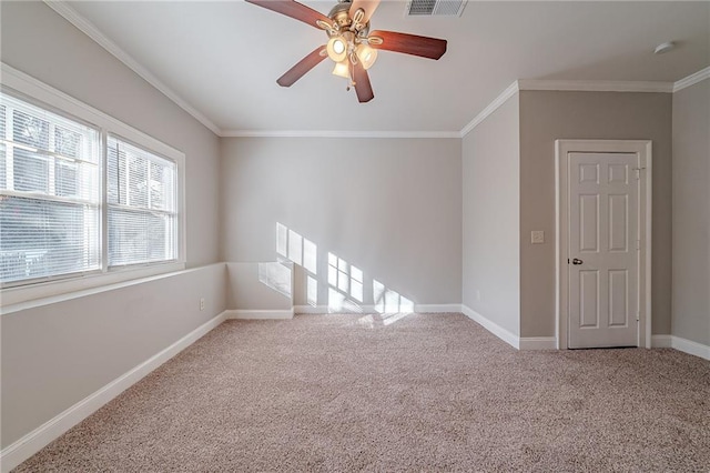 carpeted spare room featuring ceiling fan and crown molding