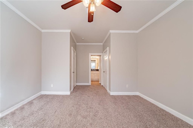 carpeted empty room featuring ceiling fan and ornamental molding