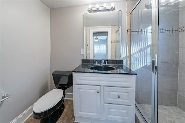 bathroom featuring walk in shower, vanity, tile patterned floors, and toilet