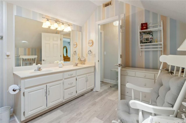 4135 Ashford Way, Gainesville, GA 30507 - full bathroom with wallpapered walls, visible vents, wood finished floors, and a sink
