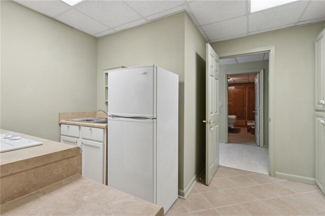 4135 Ashford Way, Gainesville, GA 30507 - kitchen featuring light tile patterned floors, a drop ceiling, freestanding refrigerator, baseboards, and light countertops