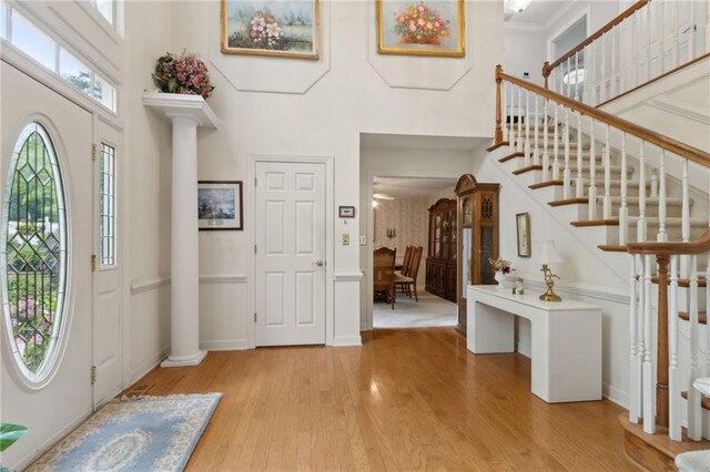 4135 Ashford Way, Gainesville, GA 30507 - foyer entrance with wood finished floors, a towering ceiling, ornate columns, stairway, and baseboards