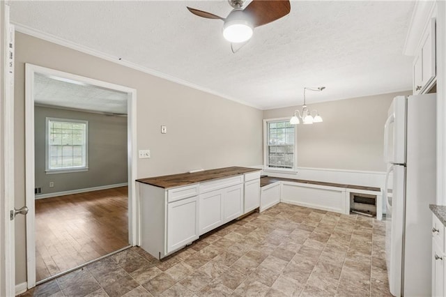 6010 White Oak Ct NW, Kennesaw, GA 31052 - kitchen featuring freestanding refrigerator, ceiling fan, a chandelier, a textured ceiling, and white cabinets