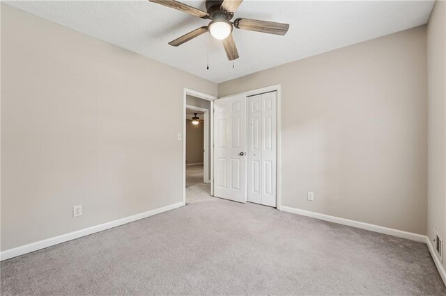 6010 White Oak Ct NW, Kennesaw, GA 31052 - unfurnished bedroom with light colored carpet, a closet, and a ceiling fan