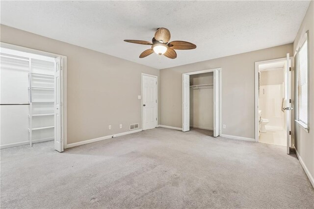 6010 White Oak Ct NW, Kennesaw, GA 31052 - unfurnished bedroom featuring carpet floors, a textured ceiling, multiple windows, ceiling fan, and ensuite bathroom