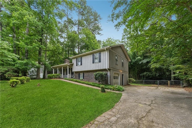 6010 White Oak Ct NW, Kennesaw, GA 31052 - split level home with driveway, a garage, brick siding, and a porch