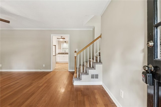 6010 White Oak Ct NW, Kennesaw, GA 31052 - entryway with ceiling fan, hardwood / wood-style floors, stairway, and crown molding