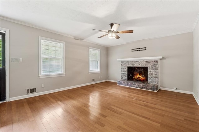 6010 White Oak Ct NW, Kennesaw, GA 31052 - unfurnished living room with ceiling fan, crown molding, wood finished floors, a brick fireplace, and a textured ceiling