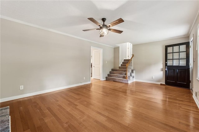 6010 White Oak Ct NW, Kennesaw, GA 31052 - unfurnished living room featuring a ceiling fan, stairway, light wood-style flooring, and ornamental molding