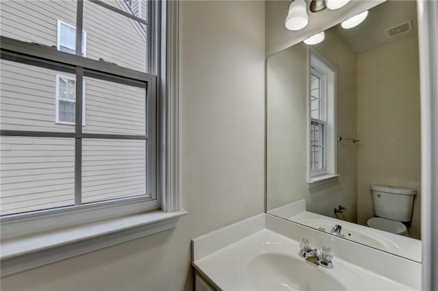 bathroom with toilet and vanity