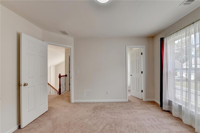 carpeted empty room with plenty of natural light