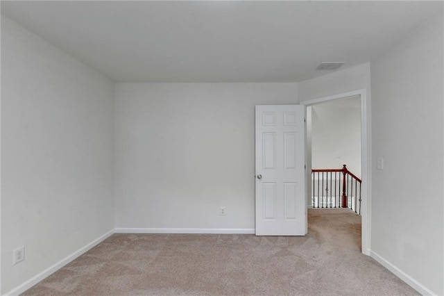 empty room featuring light colored carpet