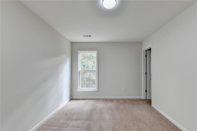 empty room featuring light colored carpet