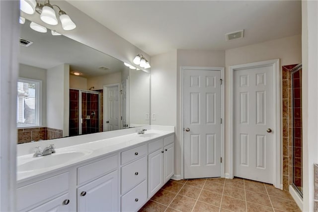 bathroom featuring vanity, walk in shower, and tile patterned floors