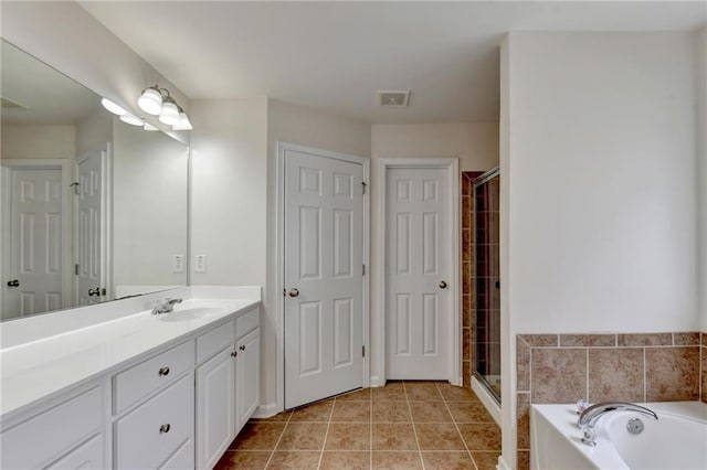 bathroom featuring vanity, shower with separate bathtub, and tile patterned floors