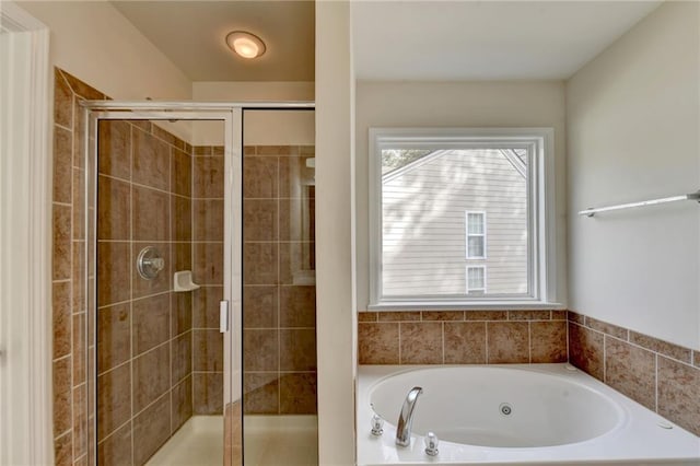 bathroom with shower with separate bathtub