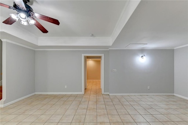 spare room with crown molding, a tray ceiling, light tile patterned flooring, and ceiling fan