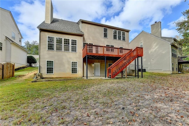 back of house featuring a wooden deck and a yard