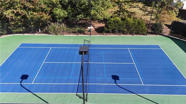 view of sport court with basketball hoop