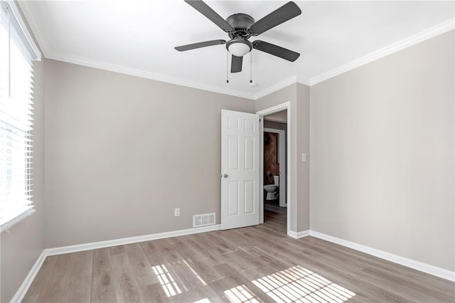 unfurnished bedroom with ceiling fan, multiple windows, and light wood-type flooring