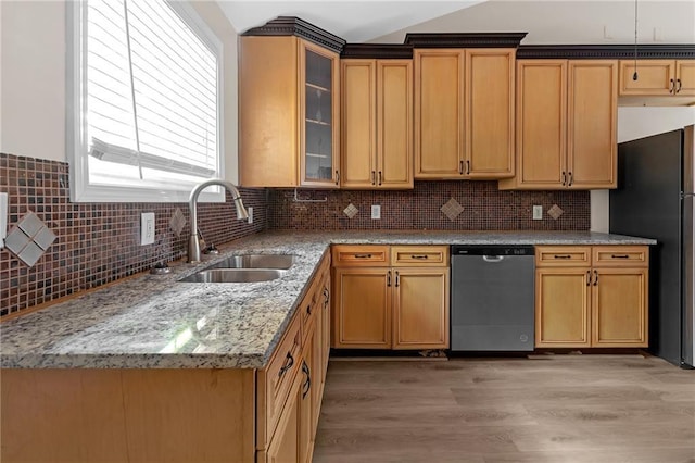 kitchen featuring light stone countertops, tasteful backsplash, sink, fridge, and stainless steel dishwasher