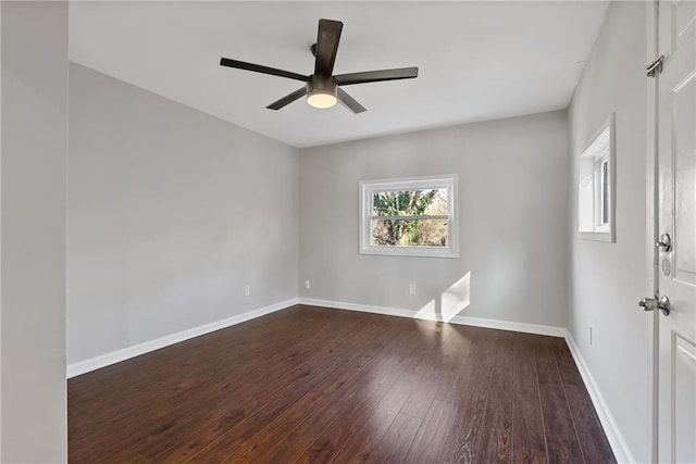 empty room with dark hardwood / wood-style floors and ceiling fan