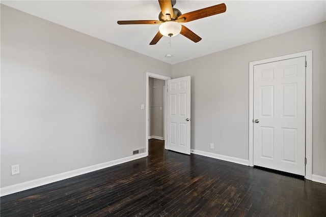 unfurnished bedroom with dark hardwood / wood-style floors and ceiling fan