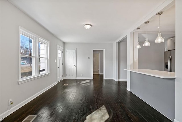 unfurnished living room with dark hardwood / wood-style floors