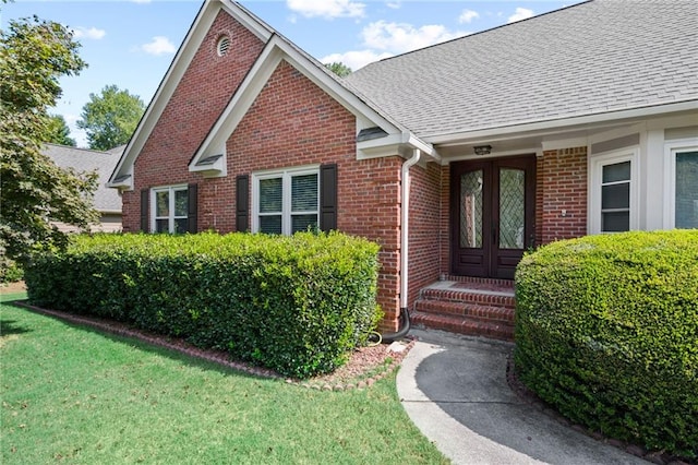 doorway to property with a yard